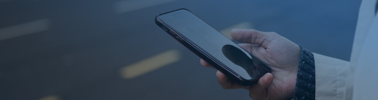 Close-up of a person scrolling on a mobile, overlaid with a blue gradient